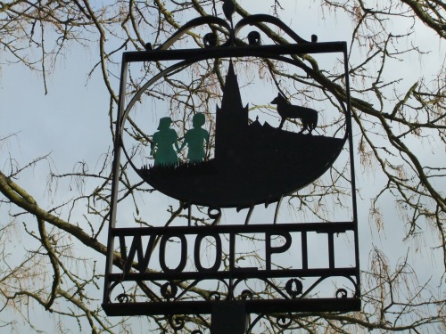 The Woolpit village sign, depicting the green children